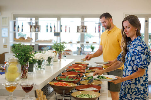 Couple getting food from the Louis Althea Lydia buffet