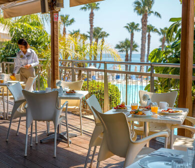 Woman serving breakfast at Louis Althea restaurant