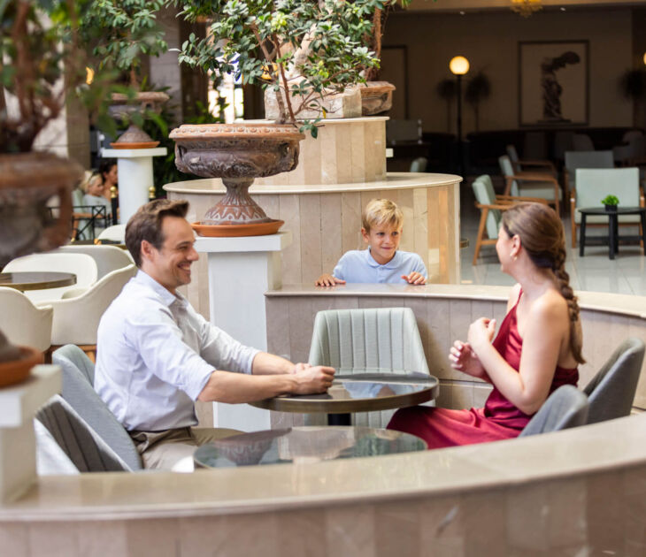 Family sitting at a table at Louis Pheathon Atrium Bar