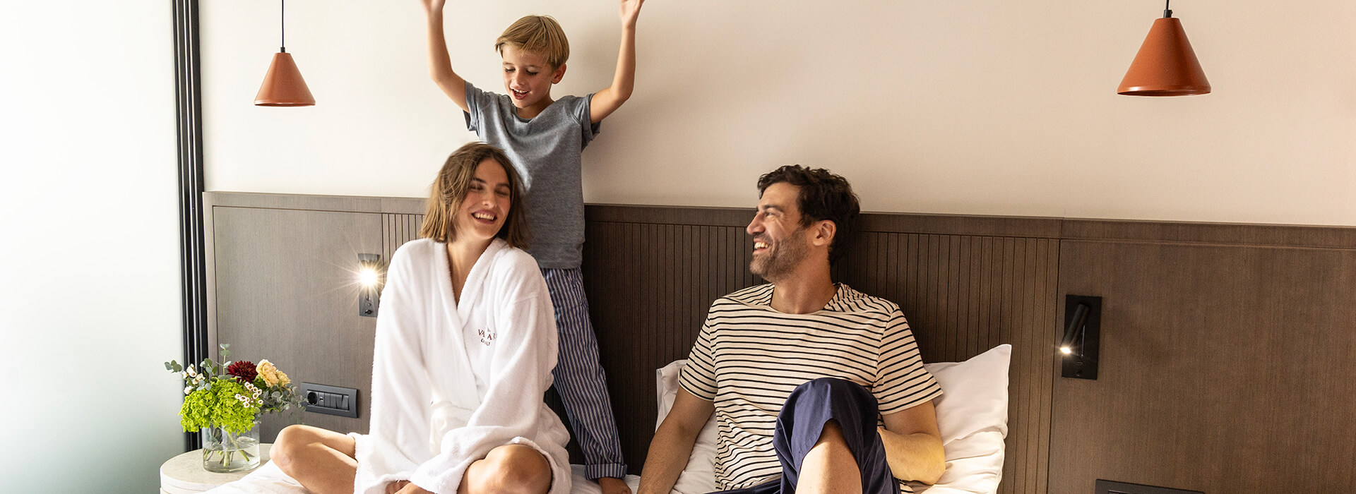 Happy family in hotel bedroom