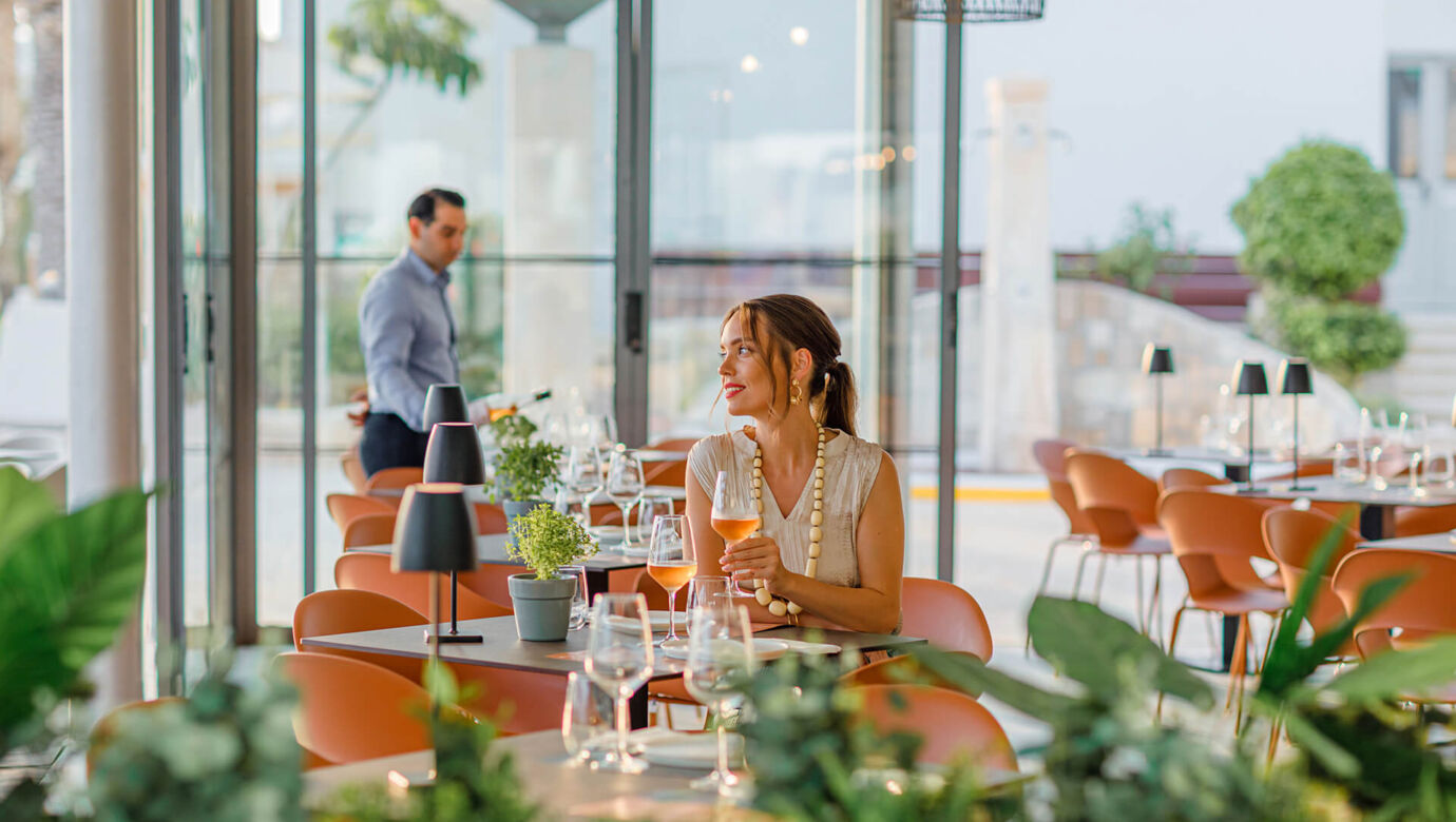 Woman sitting at a table Louis Ledra Amani restaurant