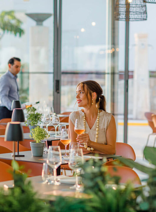 Woman sitting at a table Louis Ledra Amani restaurant