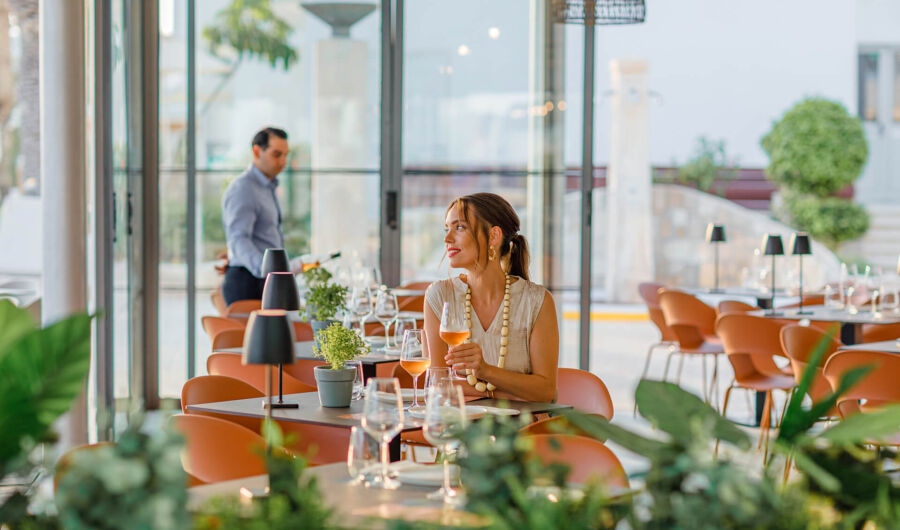 Woman sitting at a table Louis Ledra Amani restaurant