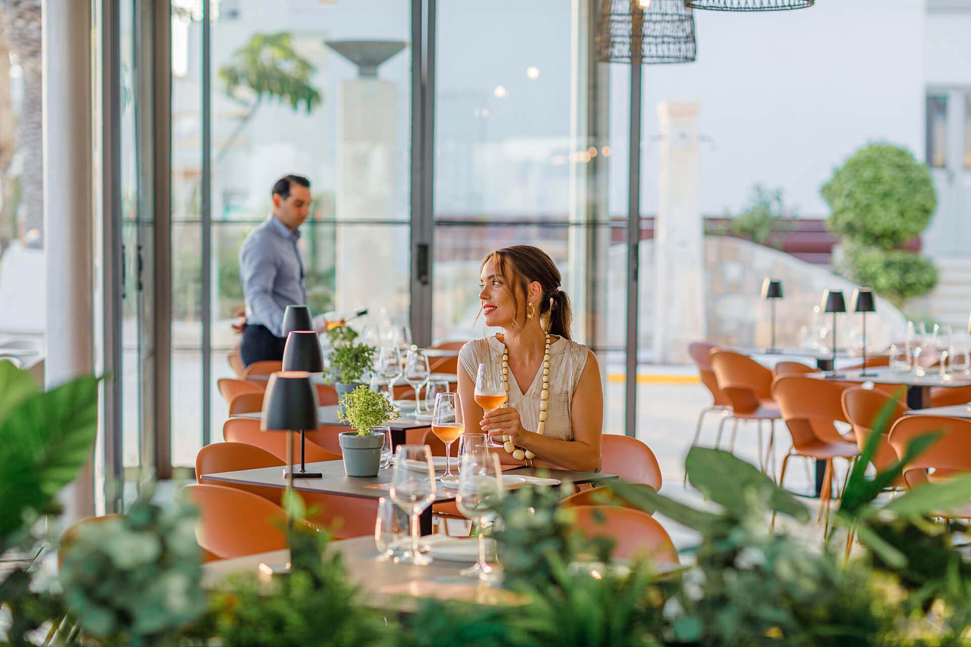 Woman sitting at a table Louis Ledra Amani restaurant