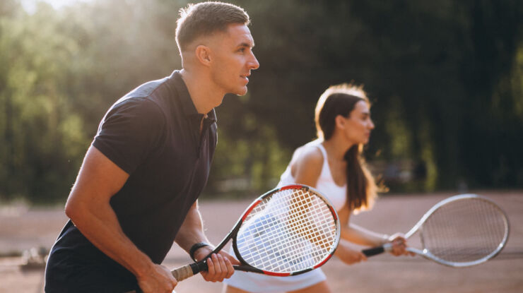Couple playing tennis at Louis Ledra Beach Hotel