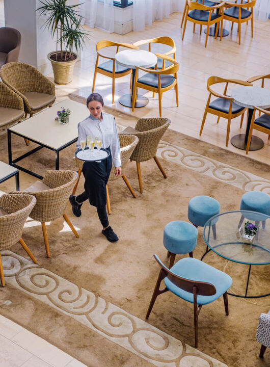 Waiter walking through Louis Ledra Gazebo Restaurant