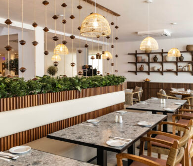 Indoor tables and wooden decorations at Louis Nausicaa Dionysos restaurant
