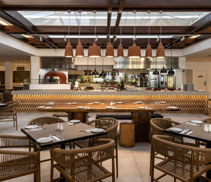 Indoor tables and kitchen at Louis Nausicaa Dionysos restaurant