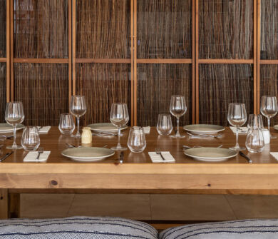 Wooden dinner table prepared for dinner at Louis Nausicaa Taverna restaurant