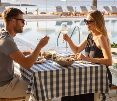 Couple eating at Louis Nausicaa Taverna restaurant pool side