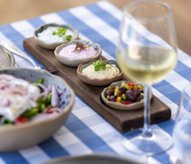 Small wooden platter with different spreads at Louis Nausicaa Taverna restaurant