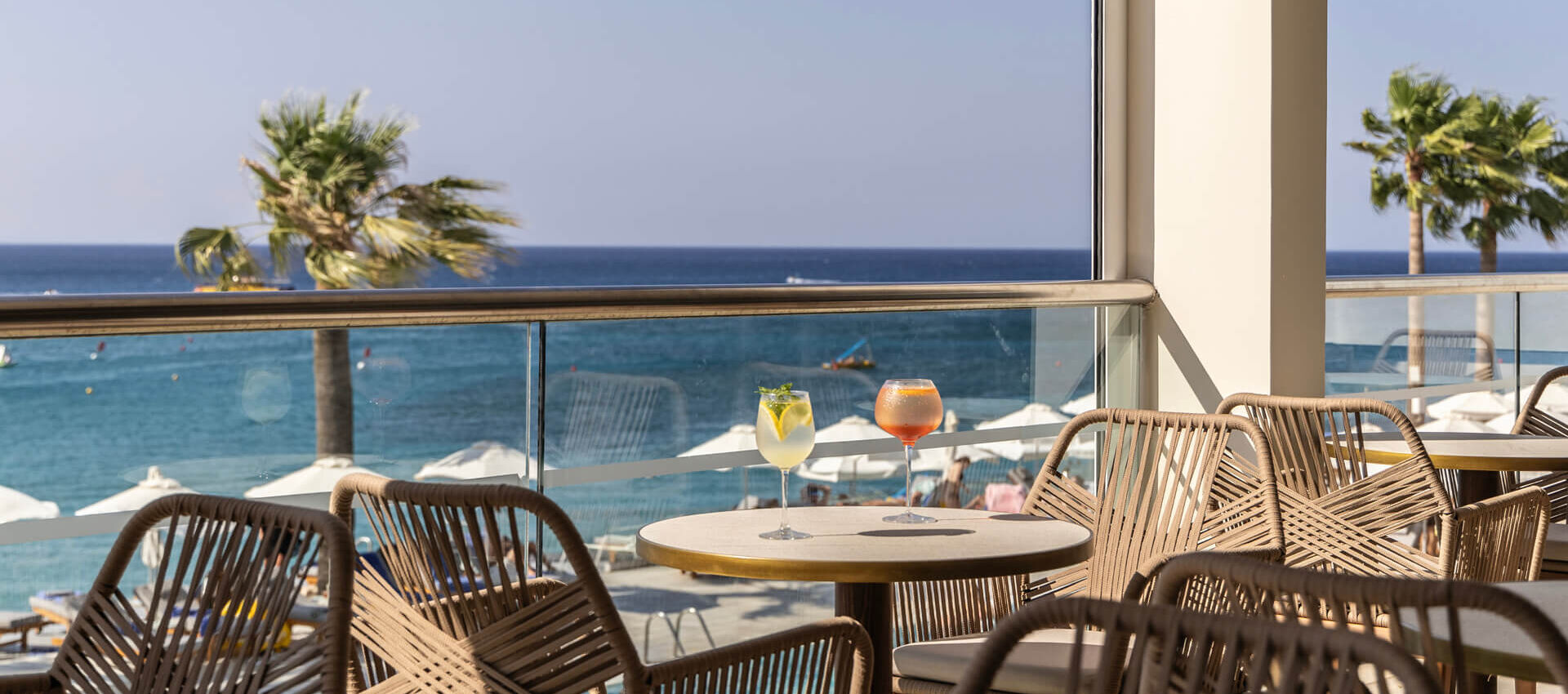 Drinks at a table at Louis Nausicaa Thea bar with sea view
