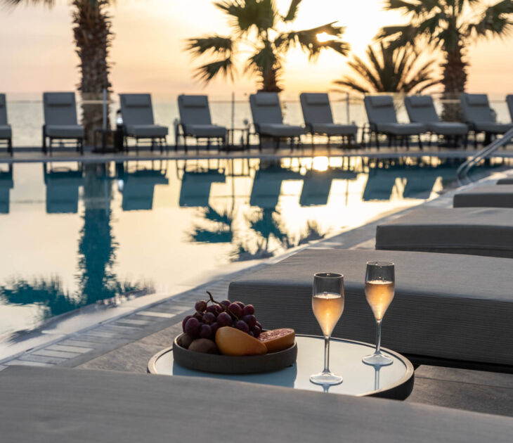Sunbeds with sidetable with snack and wine at Louis Paphos Breeze