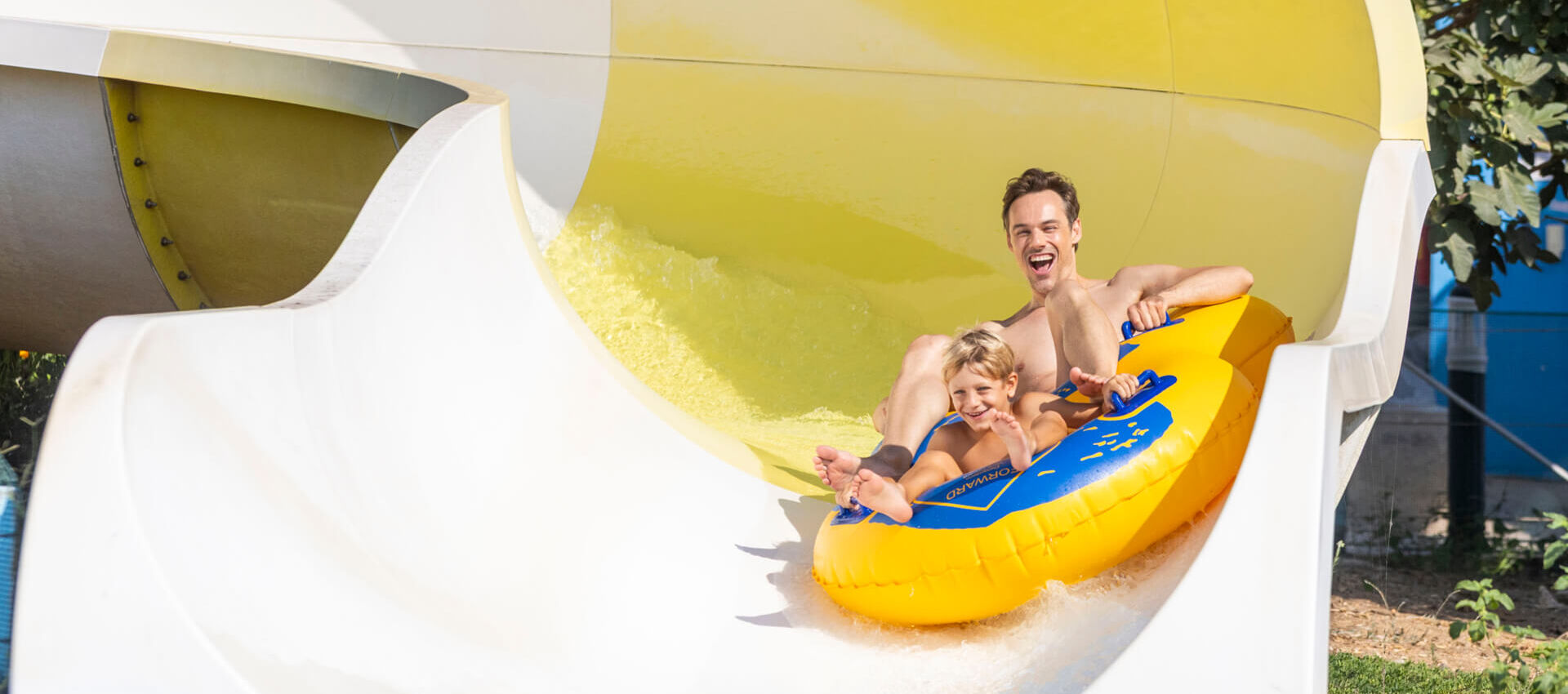 Man riding a slide at Louis Phaethon Waterpark