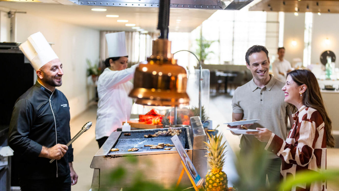 Couple laughing with a chef at Louis Phaethon Esperides Restaurant Buffet