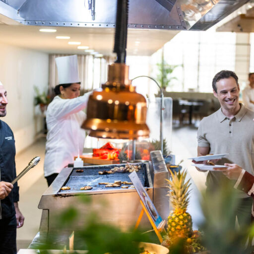 Couple laughing with a chef at Louis Phaethon Esperides Restaurant Buffet