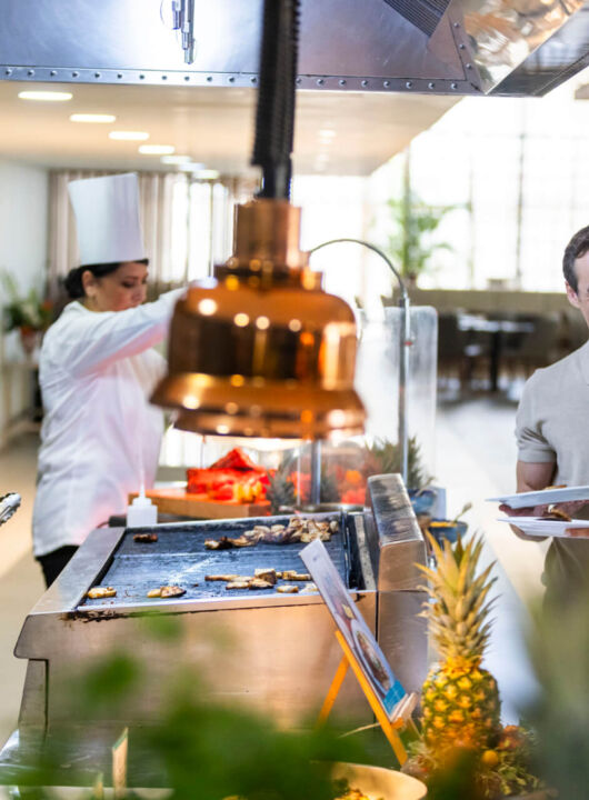Couple laughing with a chef at Louis Phaethon Esperides Restaurant Buffet