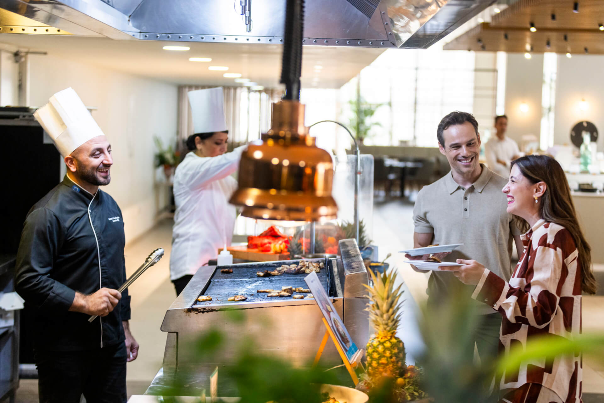 Couple laughing with a chef at Louis Phaethon Esperides Restaurant Buffet