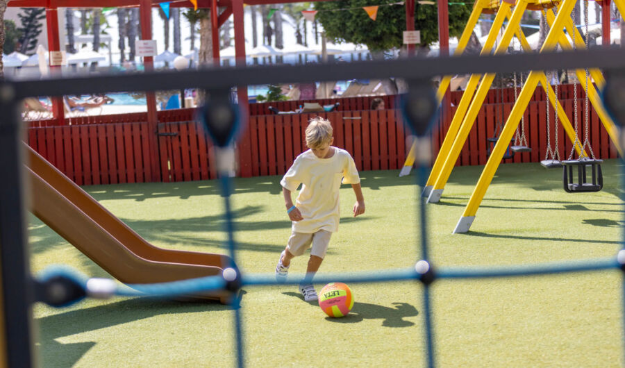 Kid playing with ball at Louis Phaethon Kids area
