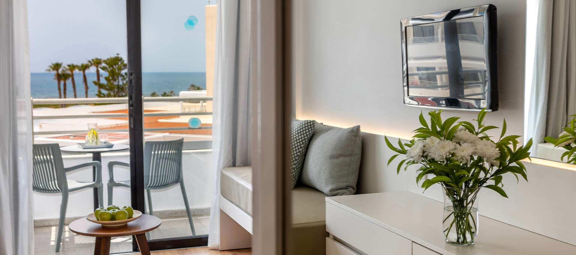 Louis Phaethon family room bedroom with sitting area and balcony with sea view