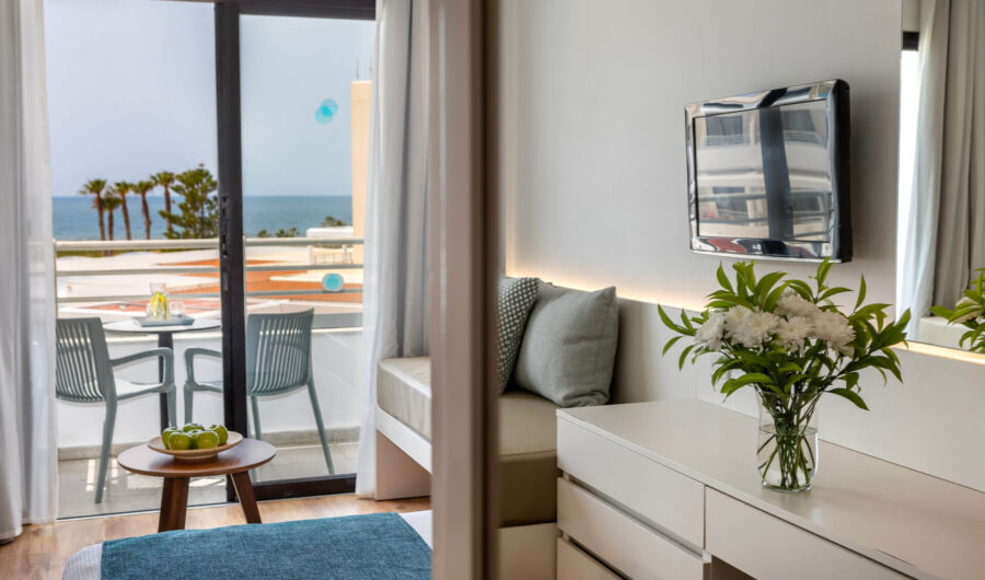 Louis Phaethon family room bedroom with sitting area and balcony with sea view