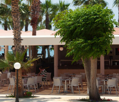 Louis Phaethon Helios bar outdoor tables and a man in the front walking