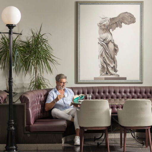 Man sitting and reading book at Louis Phaethon