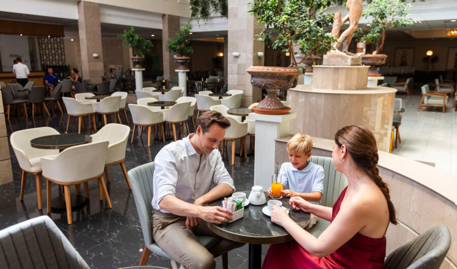 Family sitting at table and talking in Louis Phaethon