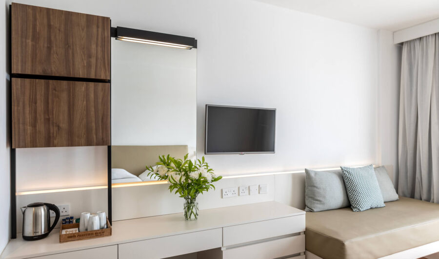 Louis Phaethon twin room sitting area with mirror and flowers