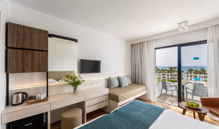 Louis Phaethon twin room bedroom with sitting area and balcony with sea view