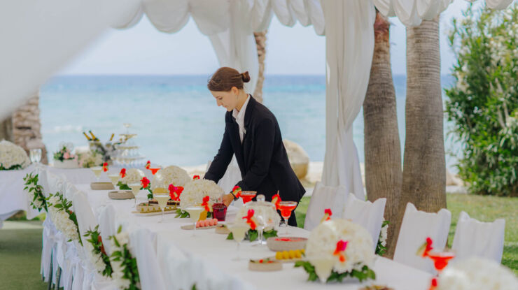 Waiter preparing wedding decorations at Louis Phaethon garden