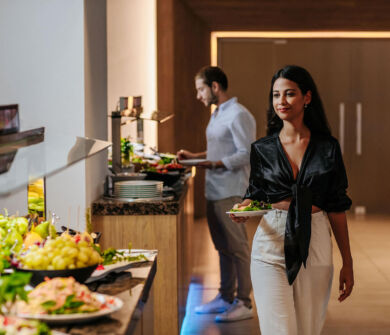 Woman getting food at Sofianna Resort restaurant buffet