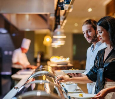 Woman getting food at Sofianna Resort restaurant buffet