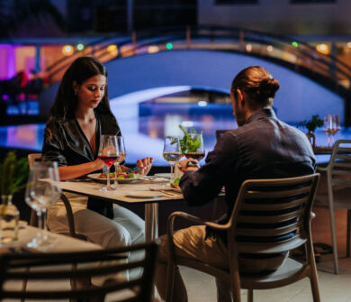 Couple eating pool side at at Sofianna Resort restaurant
