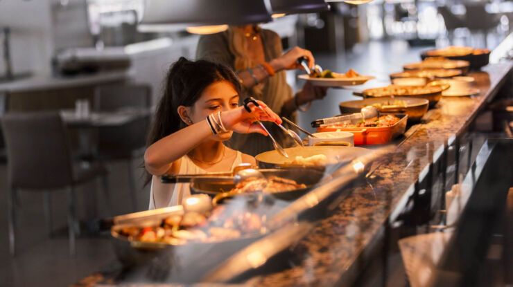 Child getting food from Sofianna Resort restaurant buffet