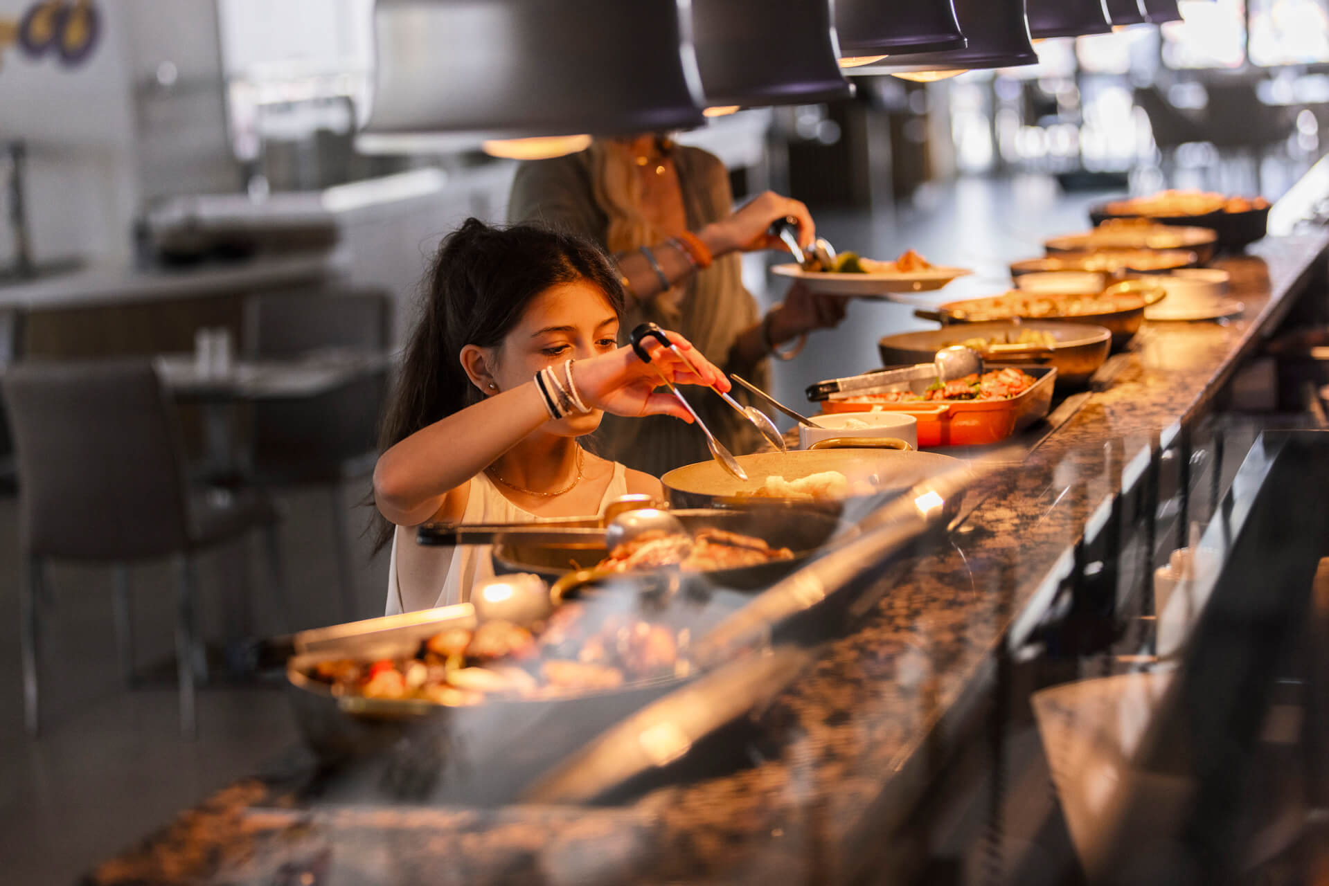 Child getting food from Sofianna Resort restaurant buffet