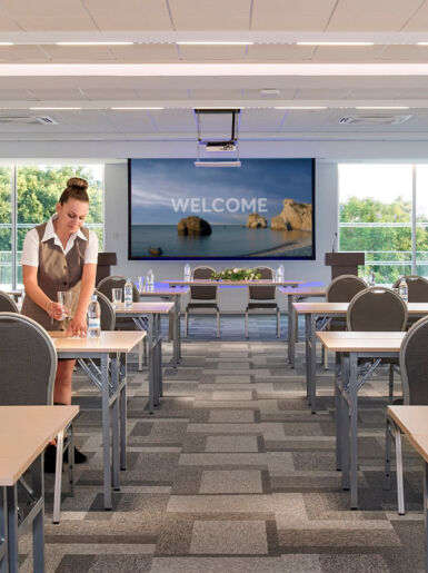 Woman preparing the Sofianna Resort Meetings space