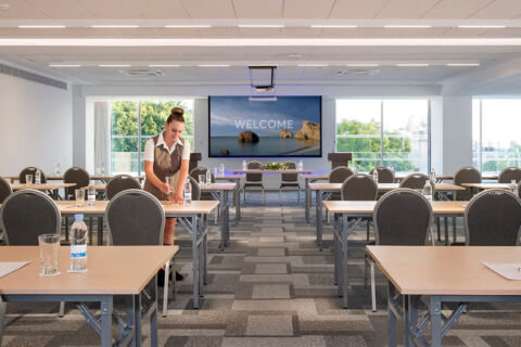 Woman preparing the Sofianna Resort Meetings space