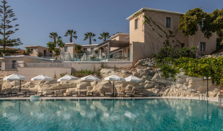 View of the pool sunbeds and rooms at Louis St.Elias
