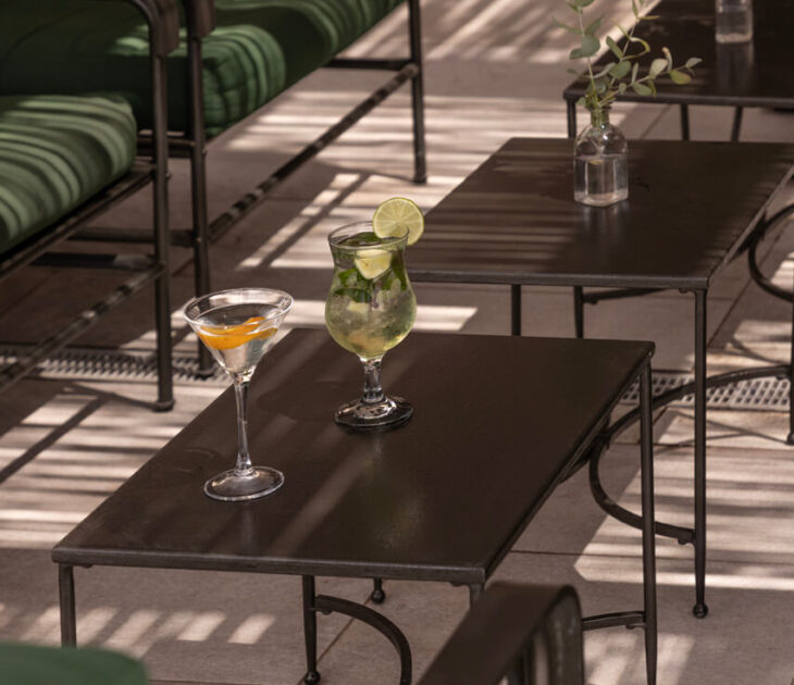 Table with two coktails at St. Elias jacaranda bar