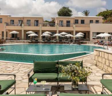 Outdoor table with pool view at St. Elias jacaranda bar