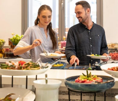 Couple getting food from buffet at St. Elias Lemon tree restaurant