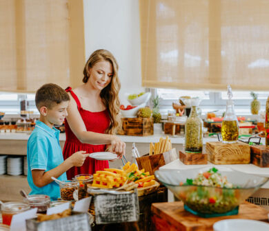 Mother and kid getting food from buffet at St. Elias Lemon tree restaurant