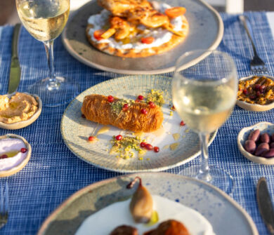 Table with traditional food , spreads and wine at Louis St, Elias Meze restaurant