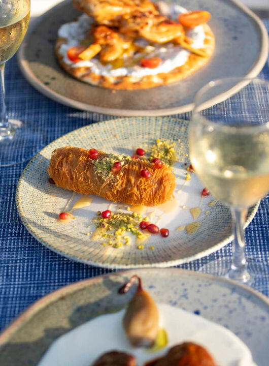 Table with traditional food , spreads and wine at Louis St, Elias Meze restaurant