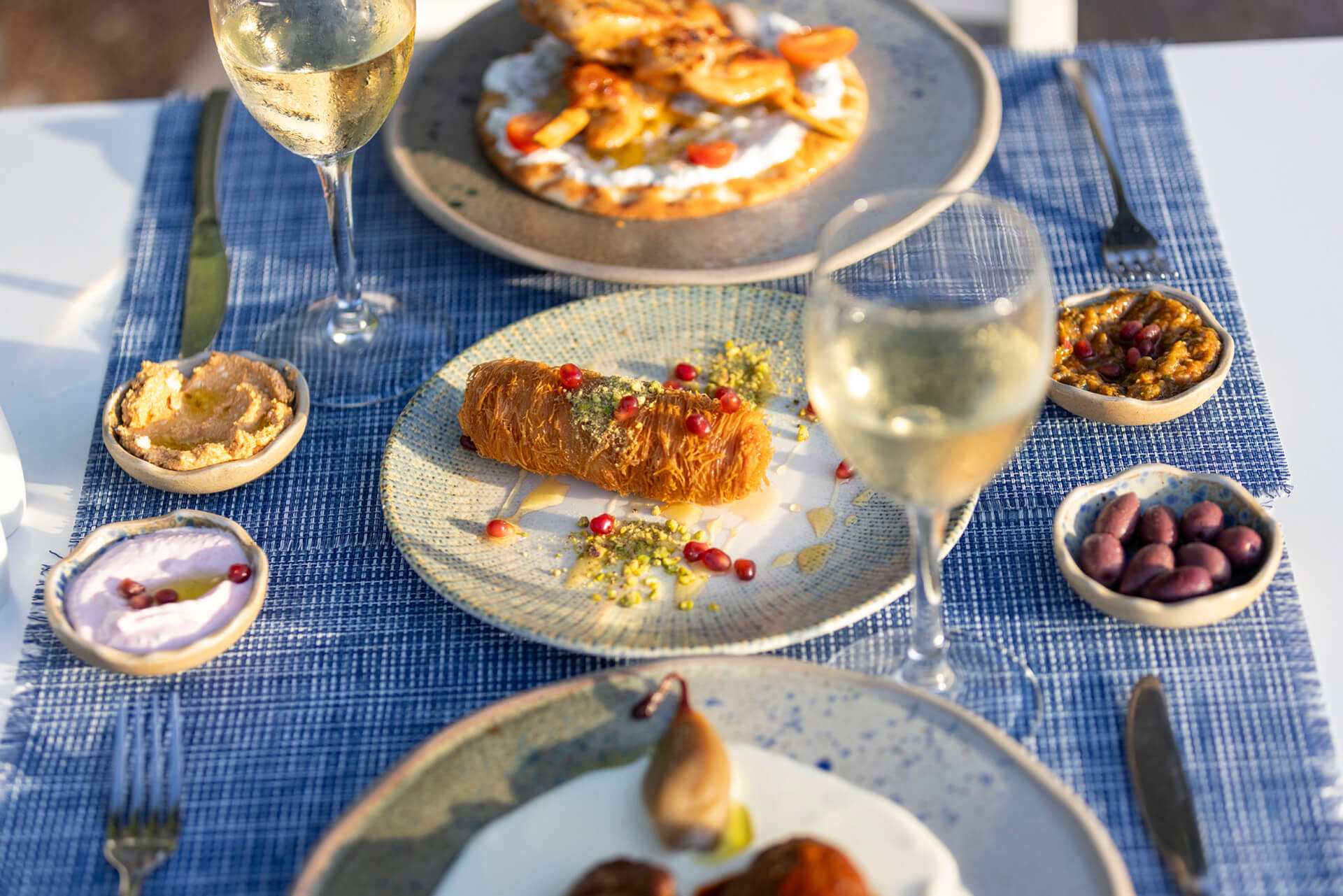 Table with traditional food , spreads and wine at Louis St, Elias Meze restaurant