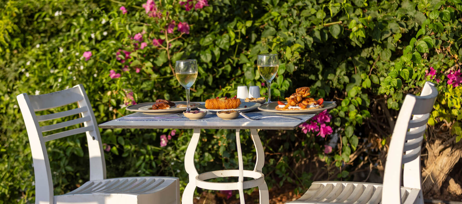 Table with traditional food , spreads and wine at Louis St, Elias Meze restaurant