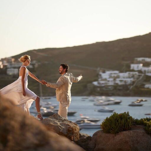 Couple walking on a rocky path at Once in Mykonos