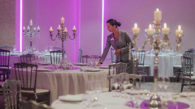 Woman setting wedding reception tables