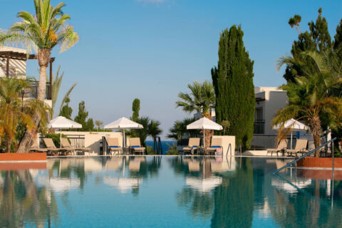 Louis Paphos Breeze pool, trees and sunbeds